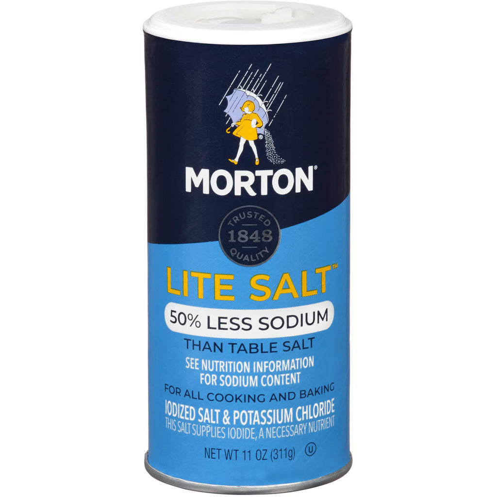 A single container of Morton Lite Salt 50% less sodium, shown on a plain white background. The cylindrical container features a dark navy blue top half with the yellow and white Morton logo, and a bright blue bottom half with yellow and white text.