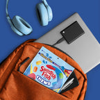 An orange backpack on a blue background, shown with a laptop, headphones, and accessories. A pack of Swedish Fish Chews is tucked into the front pocket.