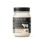 A glass jar of grass-fed beef tallow with a black lid and a black label, shown against a plain white background.